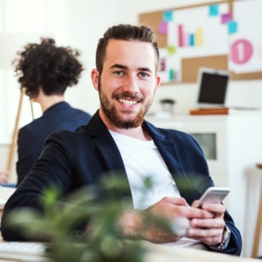 a-portrait-of-young-businessman-with-smartphone-A2GKEC4-min